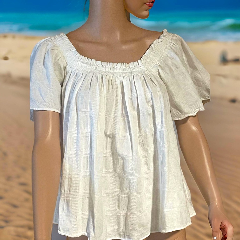 The Pants Store off the shoulder white flowy top.
